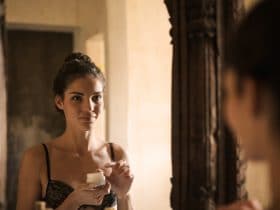 Canva Young Woman Applying Cream Near Mirror 1 1